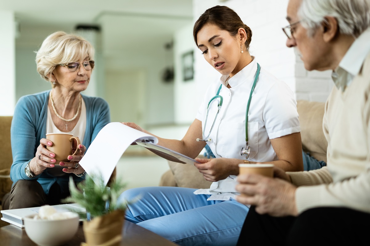 Doctor reviewing medical records with seniors.