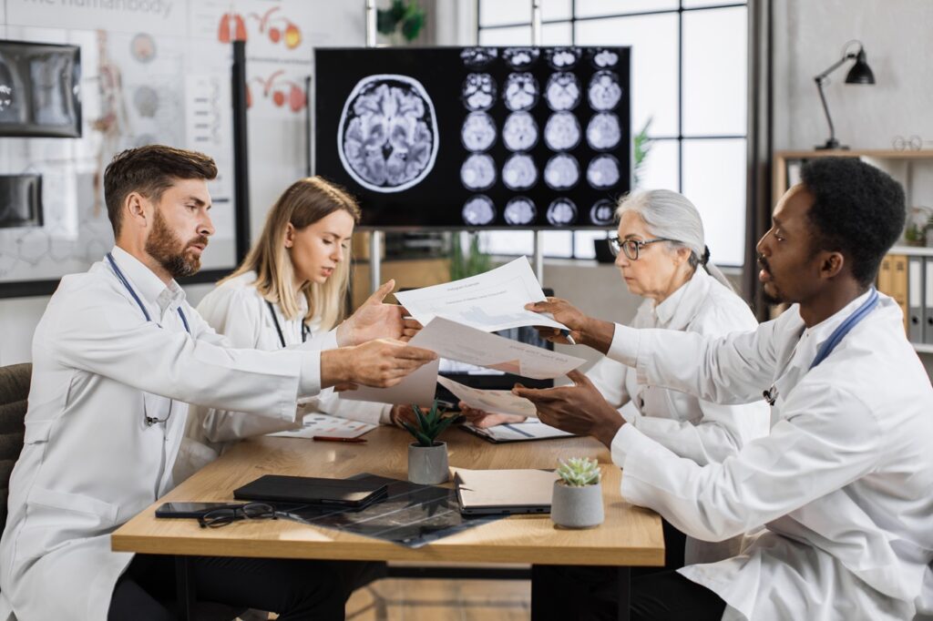 A group of doctors sitting around a table.