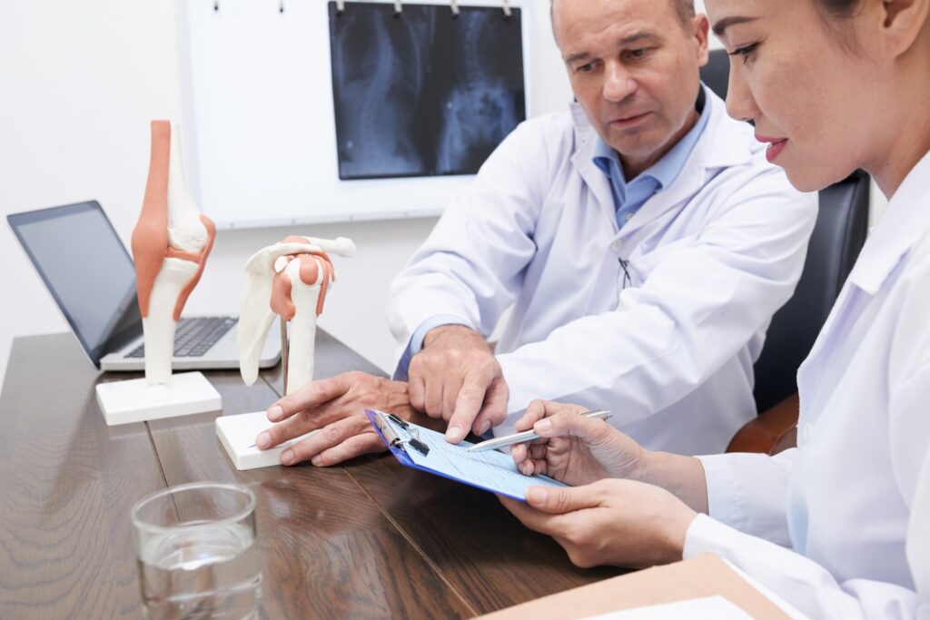 A doctor and two other doctors looking at an image.