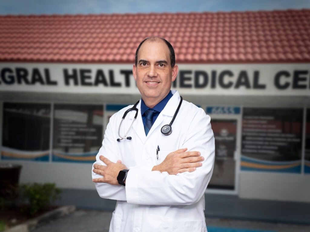 Smiling doctor in front of medical center.