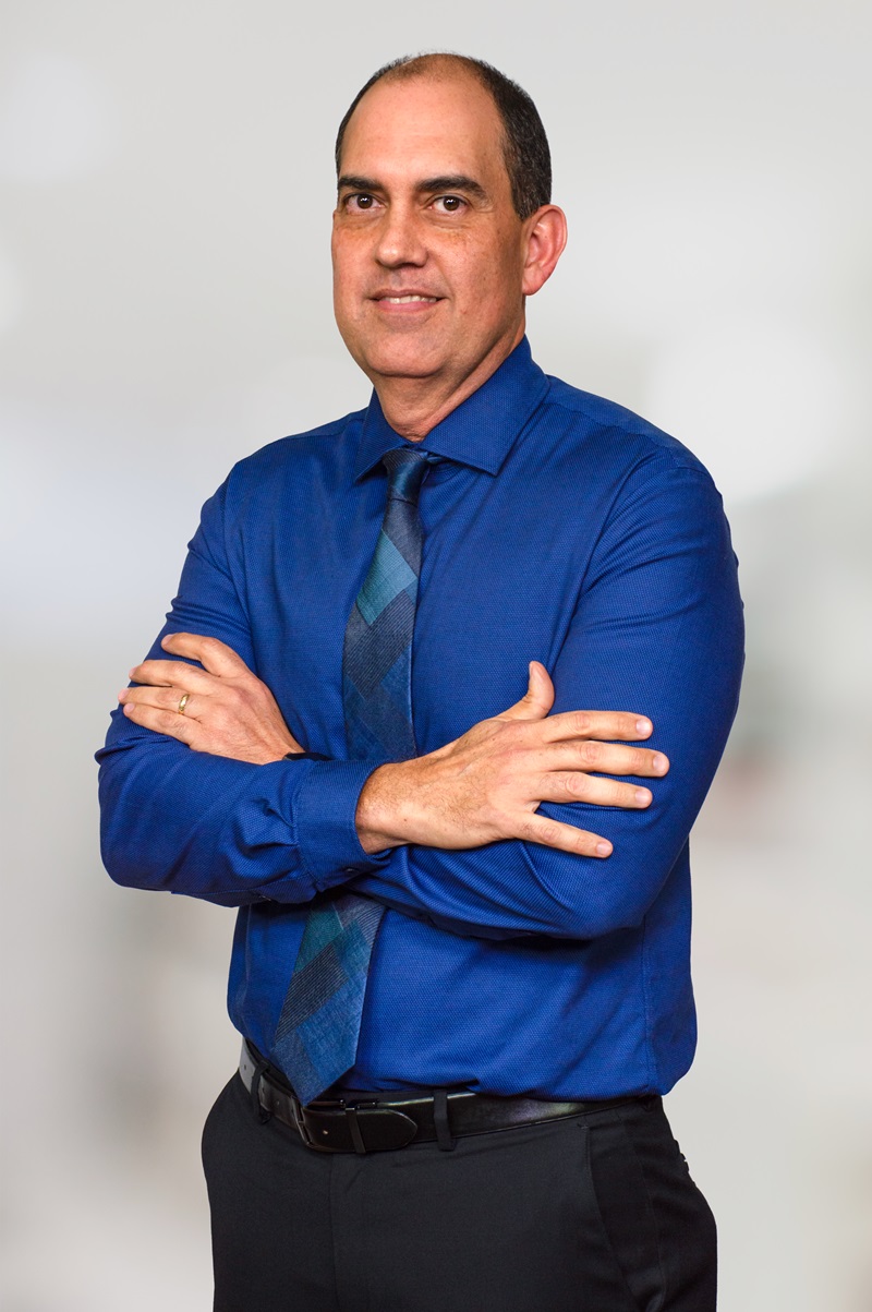 Confident businessman in blue shirt.