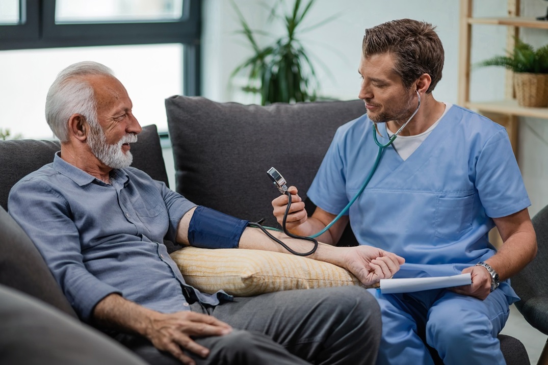 Nurse taking senior's blood pressure.