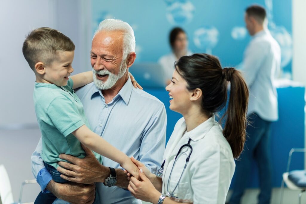 Happy grandfather, child, and doctor.