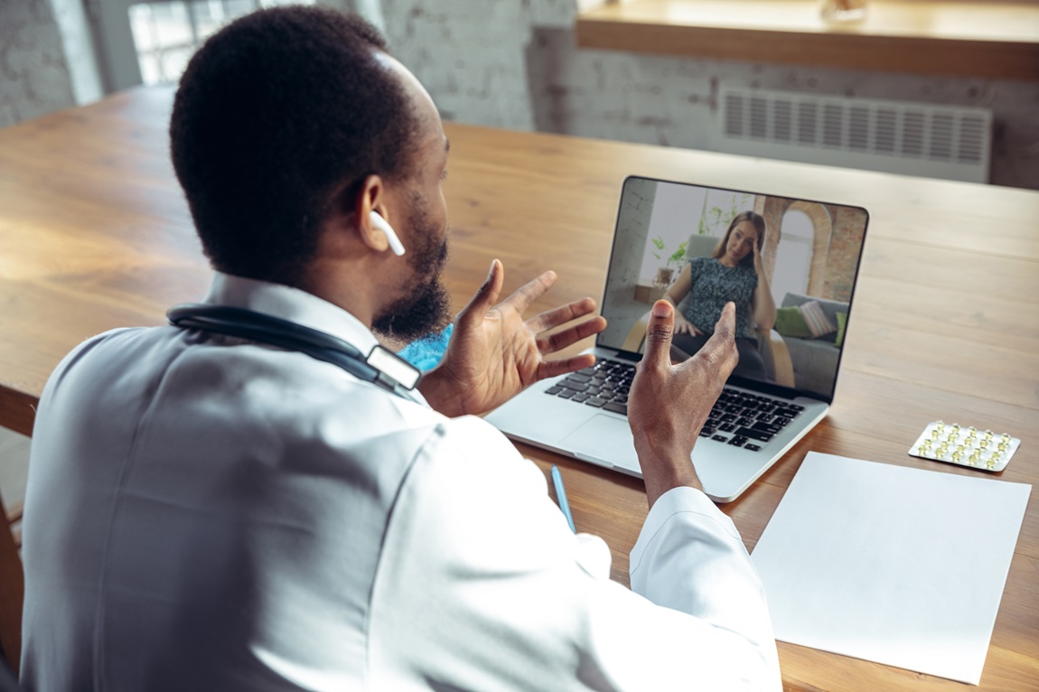 Doctor video conferencing with patient.