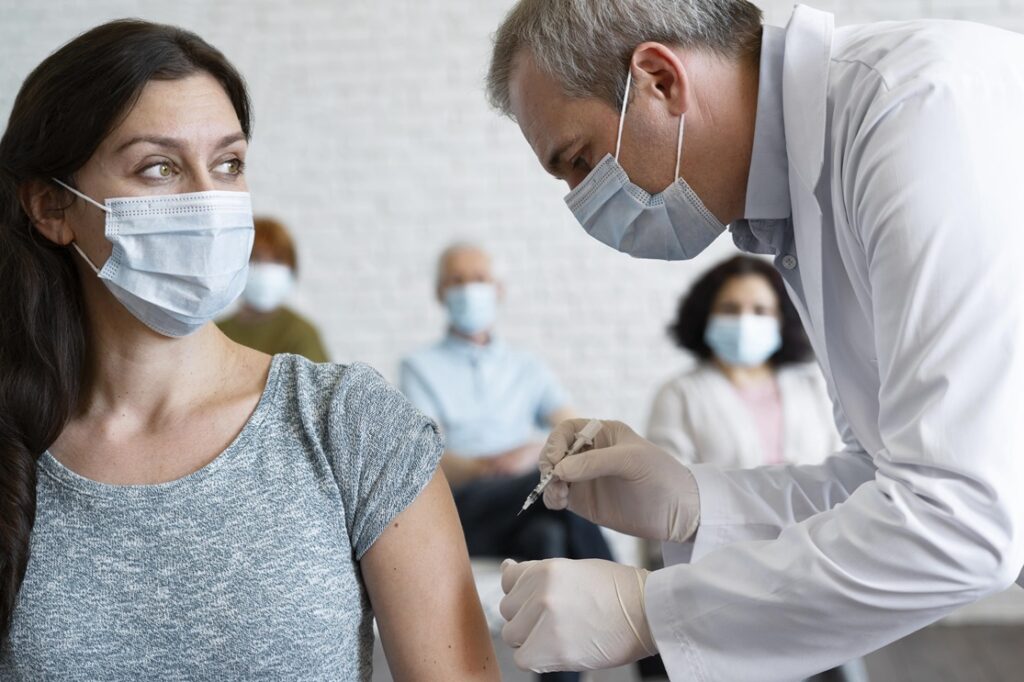 Doctor administering a vaccine shot.