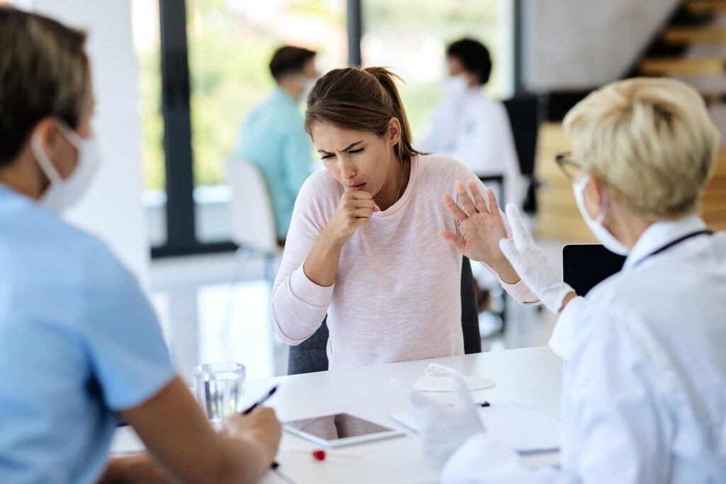 Woman coughing, doctor consultation, medical visit.