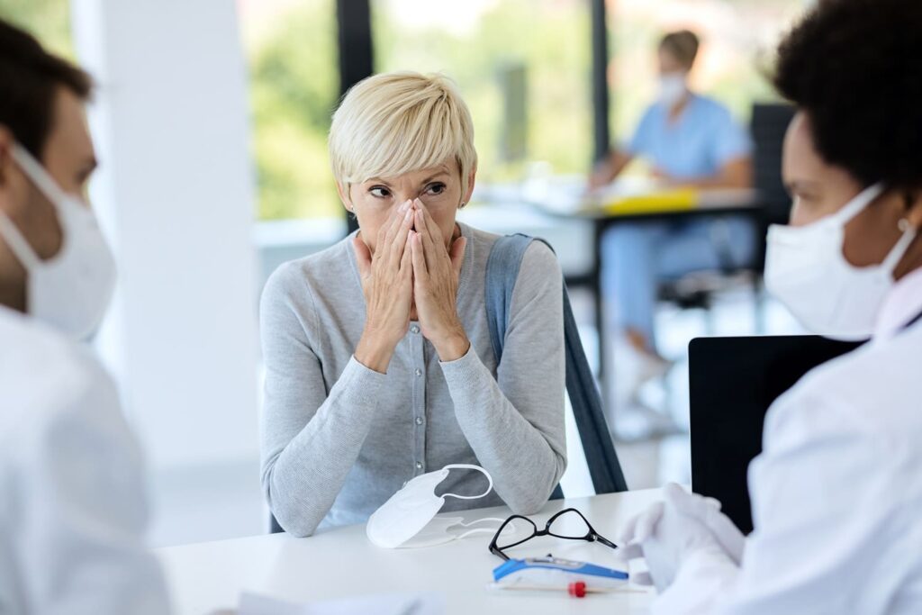 Woman worried during doctor's appointment.