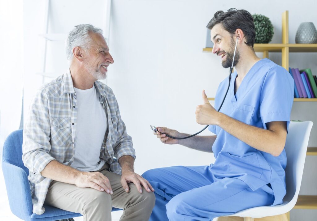 Doctor gives senior patient thumbs up.