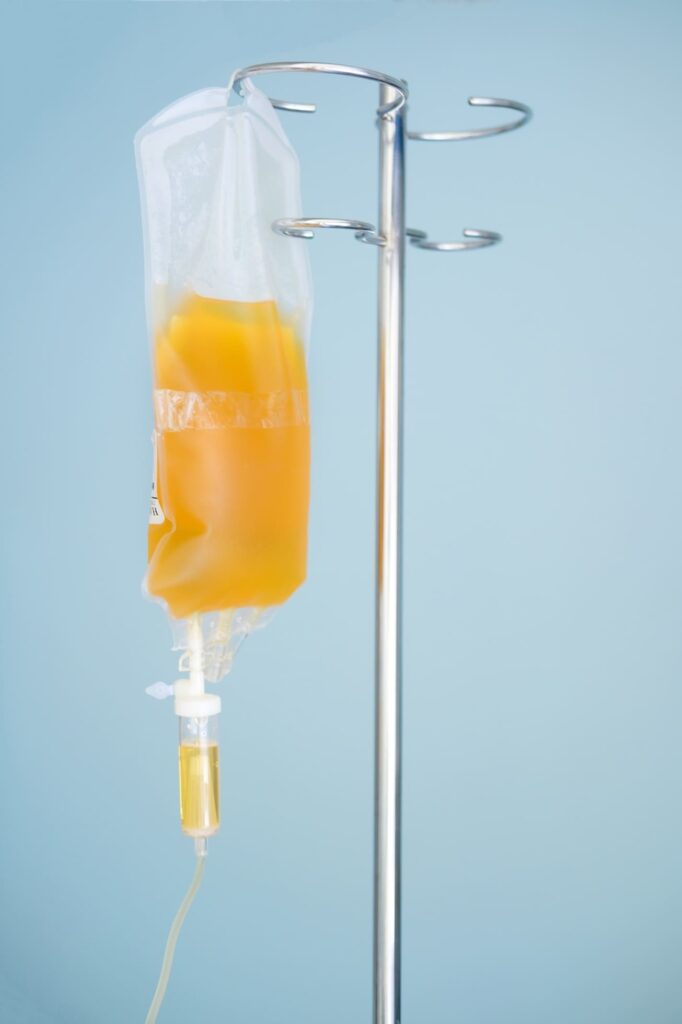 Here's an alt tag for the image: Plasma bag on IV stand.