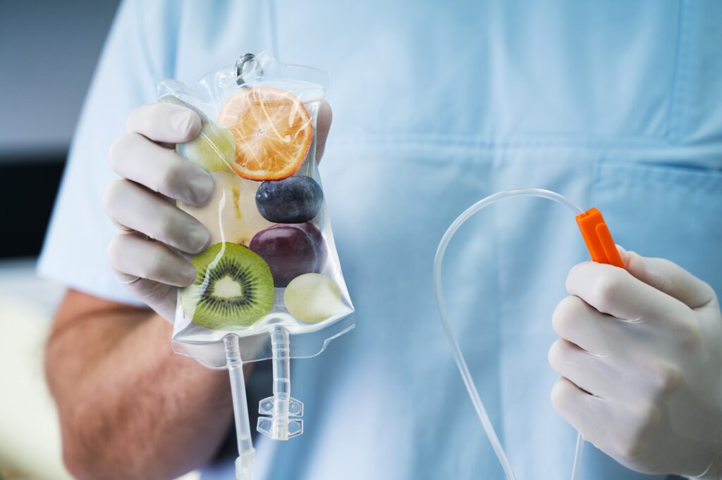 Fruit IV bag in gloved hands.